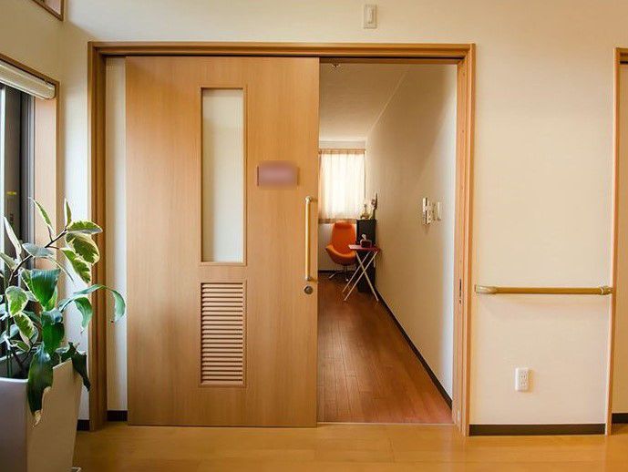 居室の出入り口に設置された手すりを使い、安全に出入りができる。扉にプレートを備えており、自分の部屋が分かりやすい。