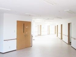 居室当の出入り口の扉以外が、白で統一されている通路