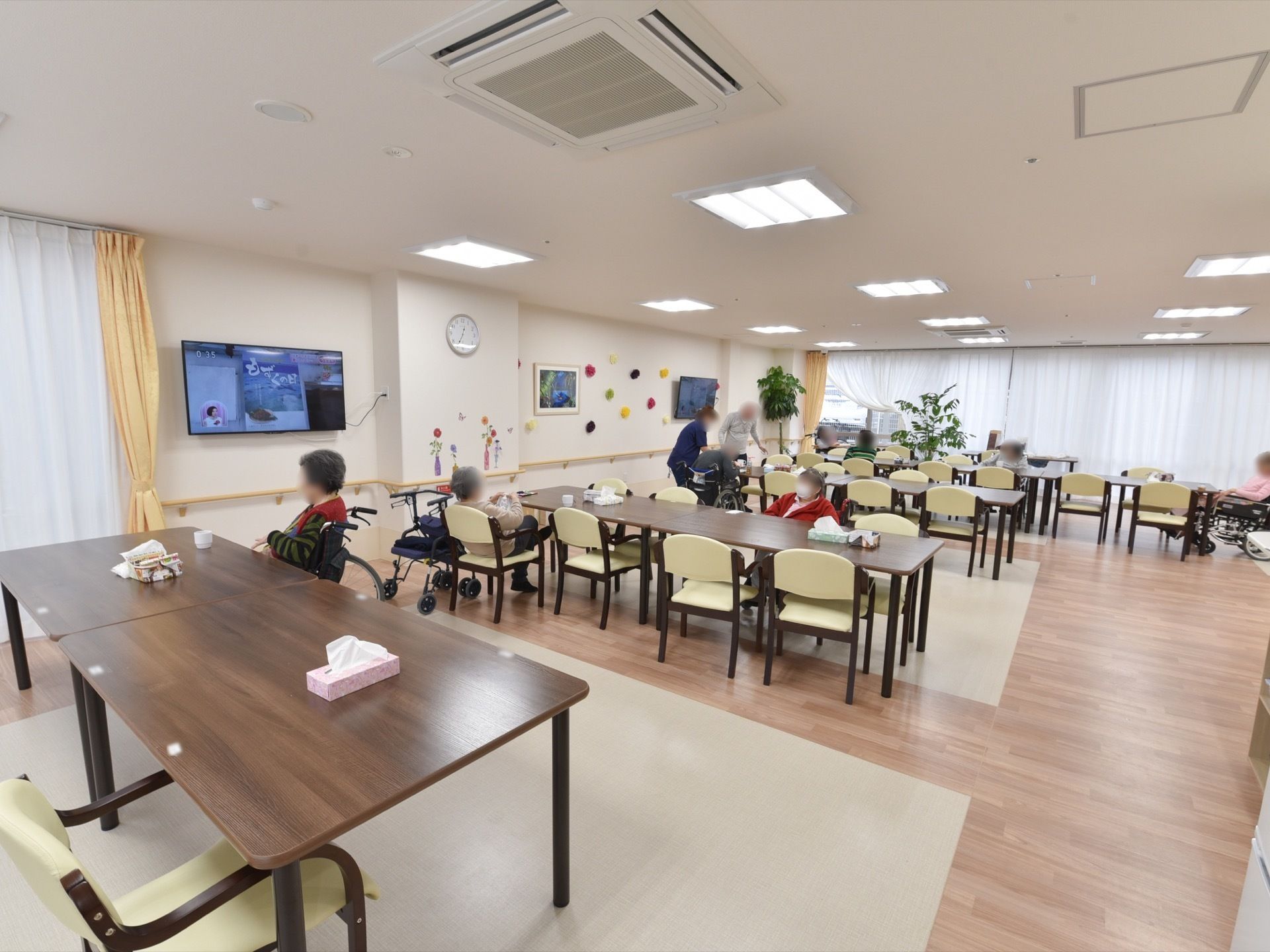 食堂のテーブルは８人がけになっており、大人数で食事を楽しめる。壁掛けのテレビや絵画が設置されている。