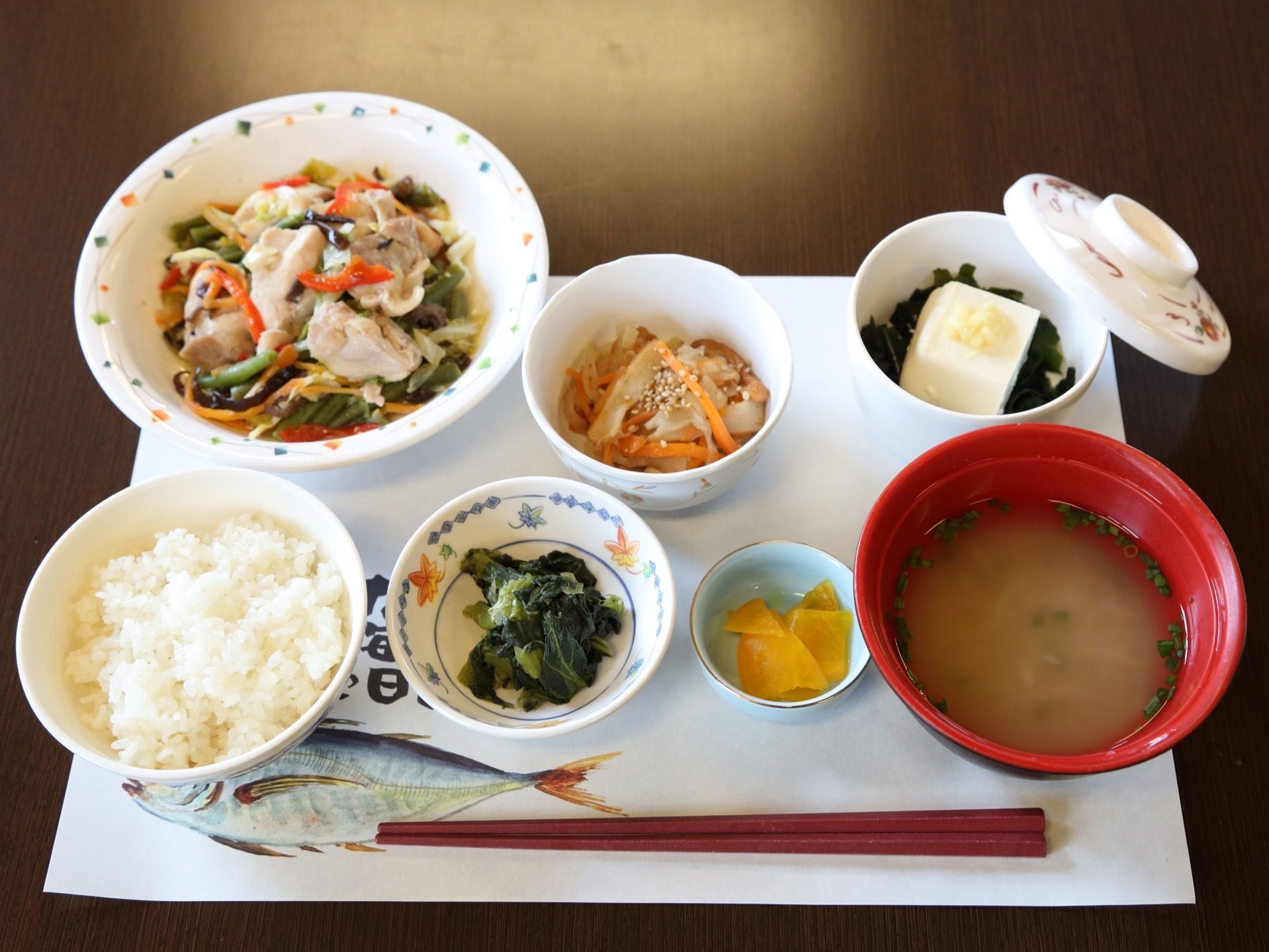 テーブルの上には、7つの器に盛られた食事が並べられている。ご飯とみそ汁を中心にバランスの考えられた食事となっている。
