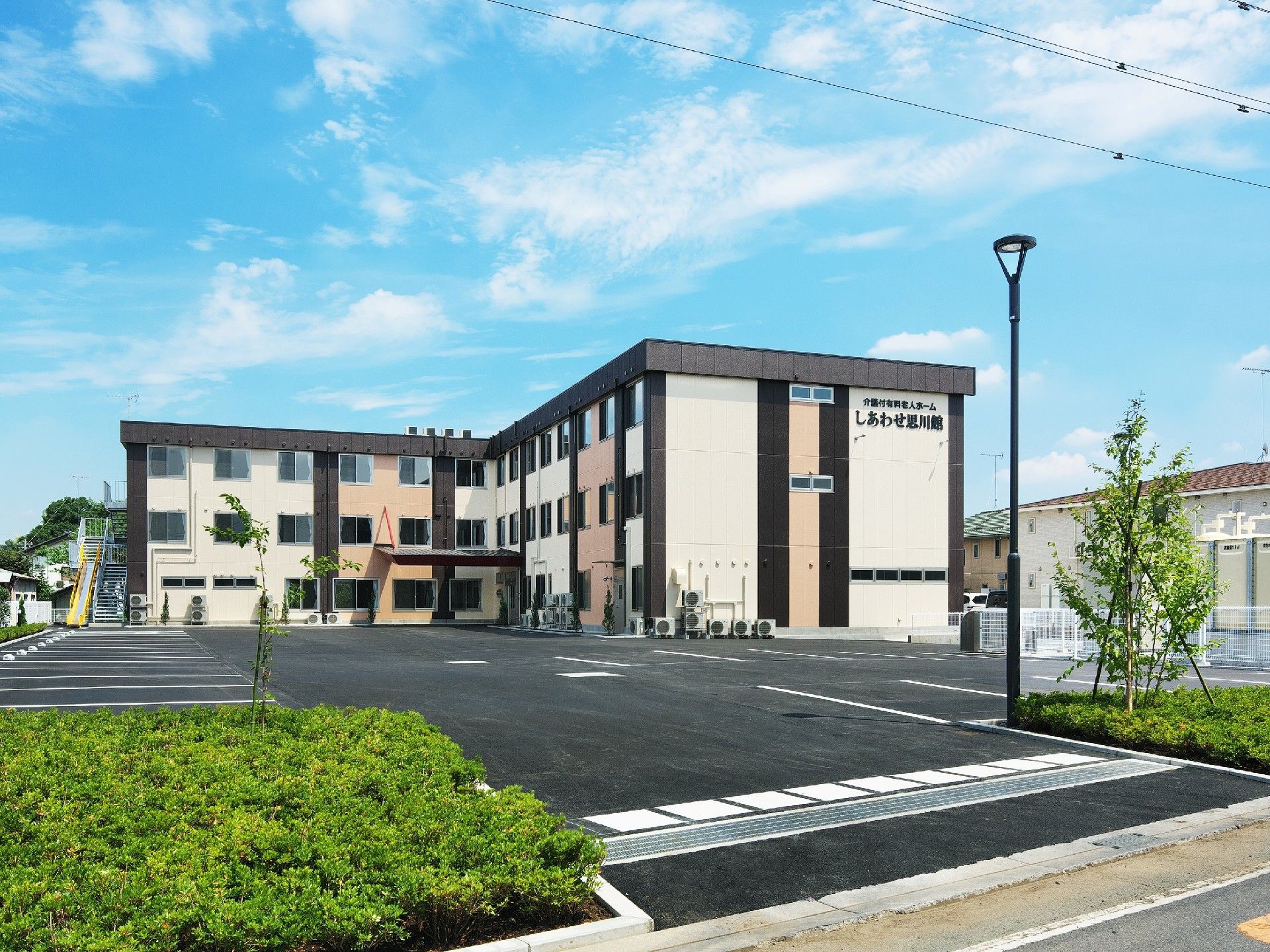 鉄骨3階建て介護付き有料老人ホームである。広い駐車場スペースを完備しているので、遠方のご家族様にも気兼ねなくお越しいただける。