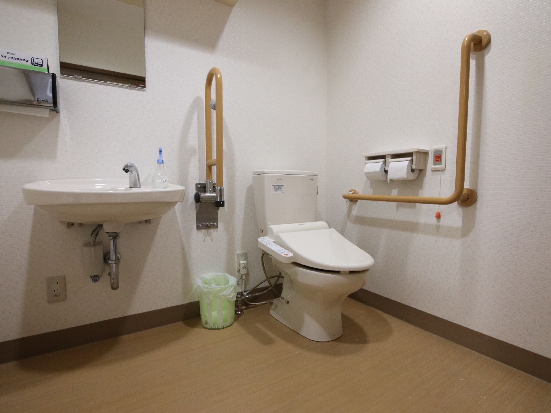 ブラウンの手すりが付いたトイレ