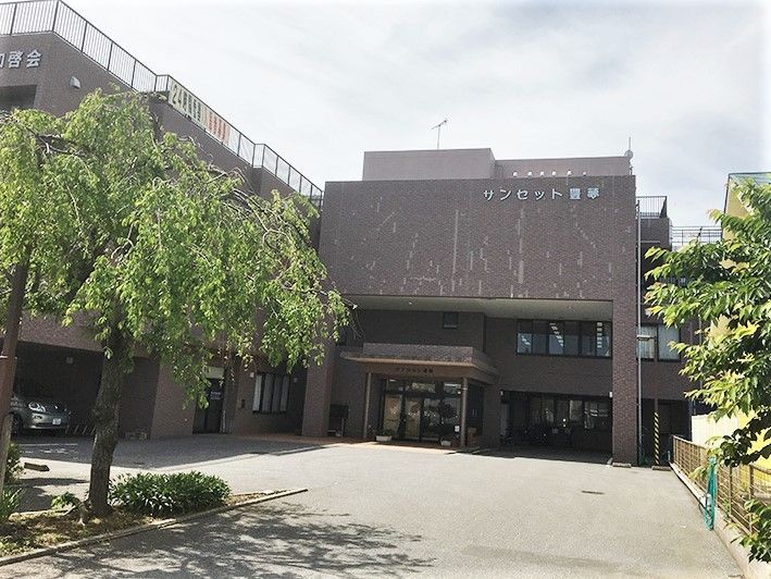 鉄骨造の大きな建物の外観写真。介護付き施設サンセット豊夢の外観スペース