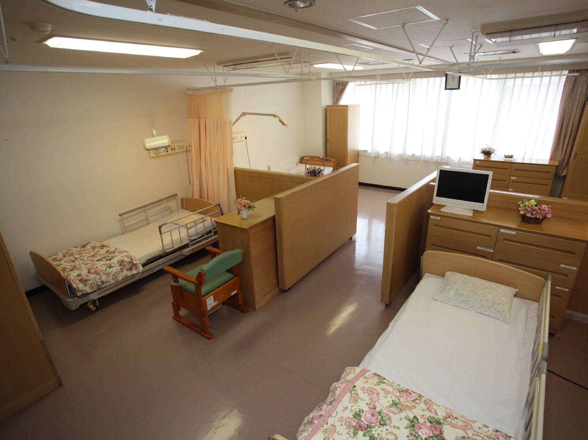 4人部屋はカーテンと家具で仕切られ、それぞれのスペースにベッドやタンスなどの家具が置かれている。