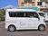 施設の駐車場に入居者様を送迎するための車が停められている。車体は白色のワンボックスで、後ろのドアに施設名が書かれている。