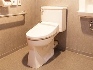居室のトイレはシンプルなデザインで手洗い場や手すり、呼び出しボタンなどが設置されている。
