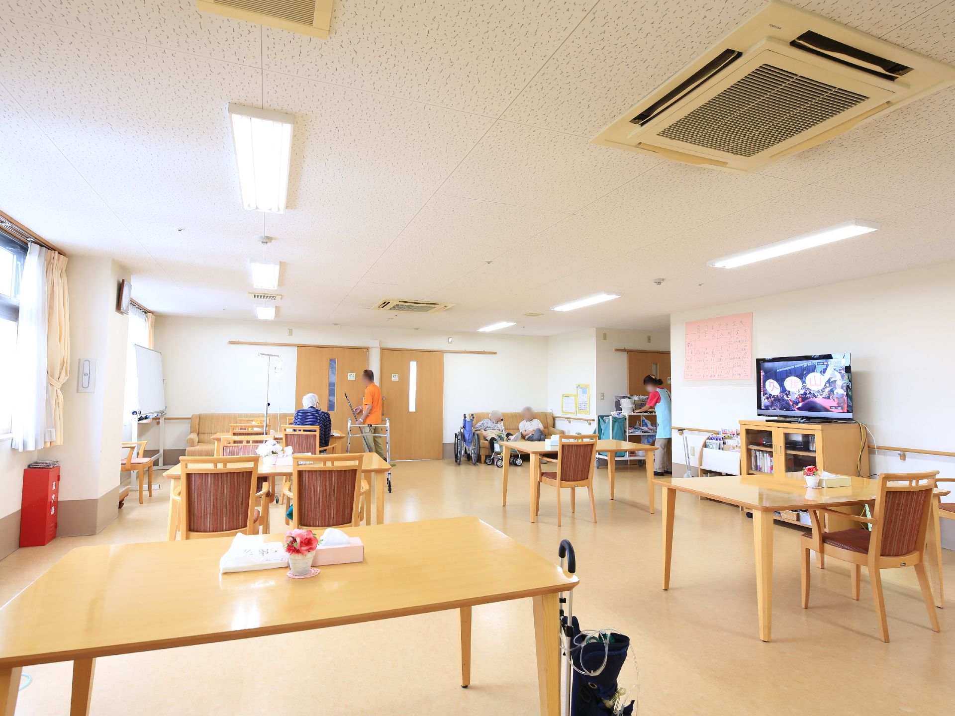 天井エアコンを設置してテーブル席を配置した、広い共有スペース