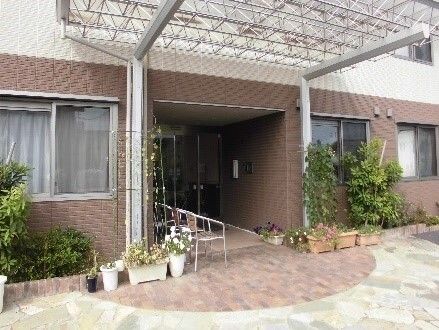 スロープ付きの施設のエントランス付近。植物の鉢が置いてある様子