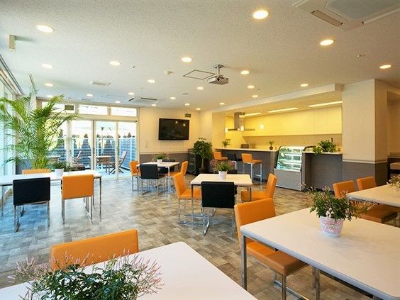 広々とした施設内の食堂、テレビのあるリラックススペースの様子