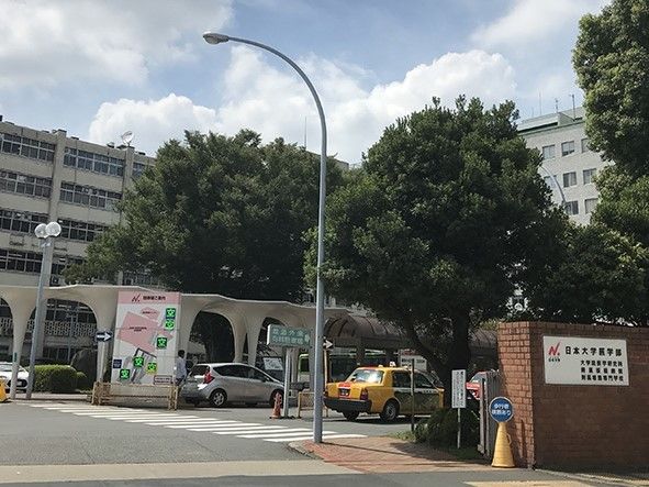 入り口には横断歩道が書かれている。構内ロータリーには屋根があり、構内案内図が置かれている。診療科が多くある病院である。