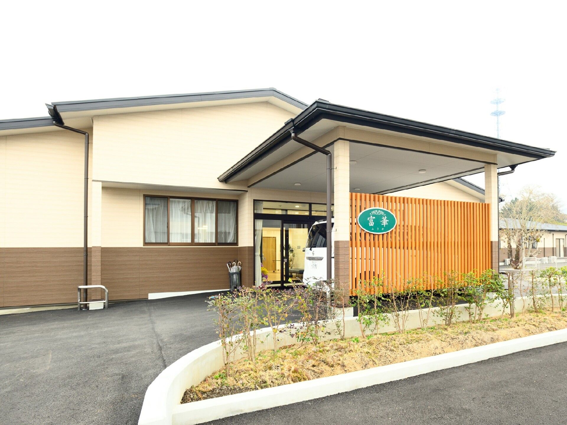 家族やスタッフと出かけている車いすの高齢者。公園のような自然豊かな場