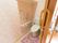 花柄のトイレマットが敷かれている。トイレットペーパーは２ロール分設置されている。便座の横にはタオルがかけられている。