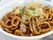 大きめなお皿に味が染み込んだめんが盛られている。キャベツと人参と豚肉と一緒にめんが炒められ、青のりとカツオ節が掛かっている。