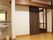 洗面台が設置された部屋。横にある茶色い引き戸が開いて、隣の部屋が見えている。床はフローリングになっている。