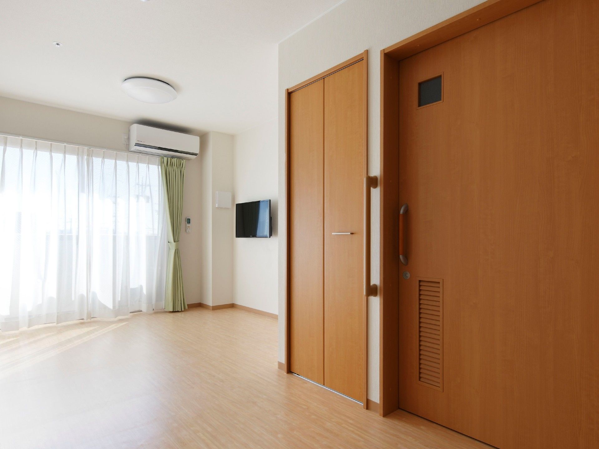 デザイナーズマンションのような、洗練された雰囲気の居室。大きな窓からは日光がよく差し、快適に過ごしていただける。