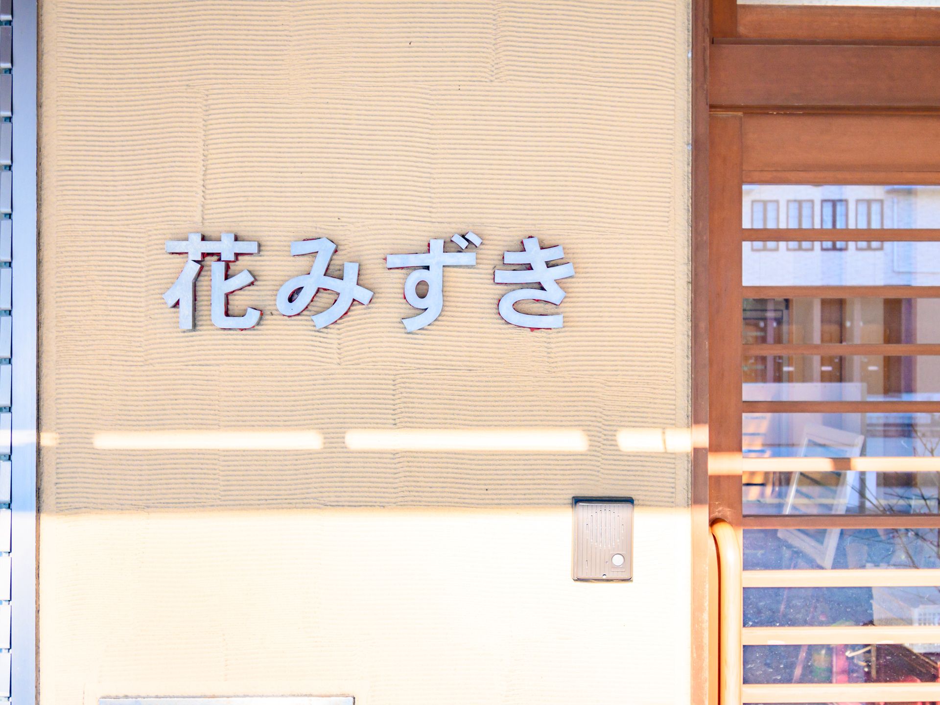 当施設名が記されたロゴが設置されている玄関