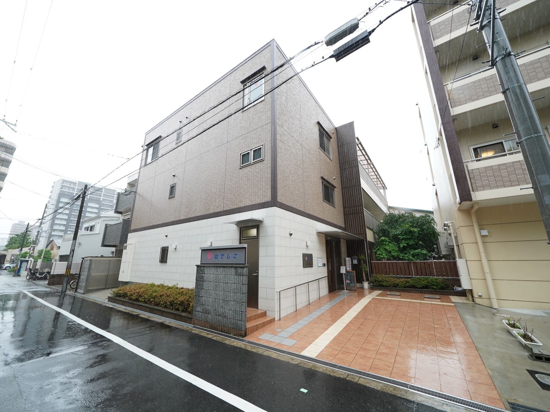 茶色の建物とオレンジのタイルが目印になっている施設の外観。住宅街の中にあるため交通の便に関しても融通が利きやすい。