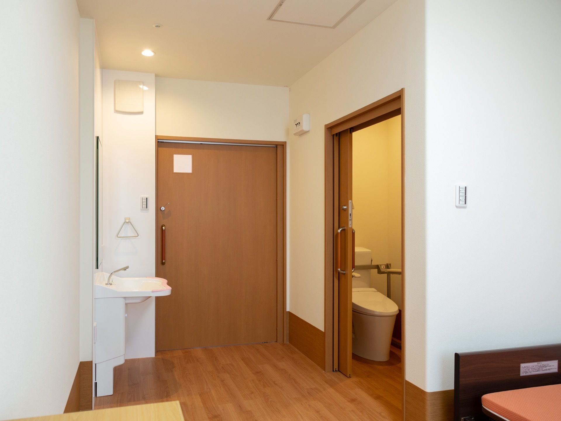 引き戸式の扉の上部に、明かり窓が設置されている。居室に入ってすぐに洗面台、トイレが備えつけられている。