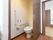 スライドドアで、入口を広めに取ってある居室のトイレである。洋式便器の横には手すりと非常ボタンが設置されている。
