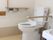 洗面所の並びにトイレを配置。バリアフリーで上げ下げできる手すりも設置してあるので、必要に応じて使える。