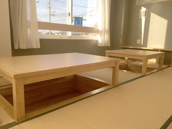 窓際にある畳の一角には、掘りごたつのように窪みを作っている。足を下に伸ばして机を利用することができる。
