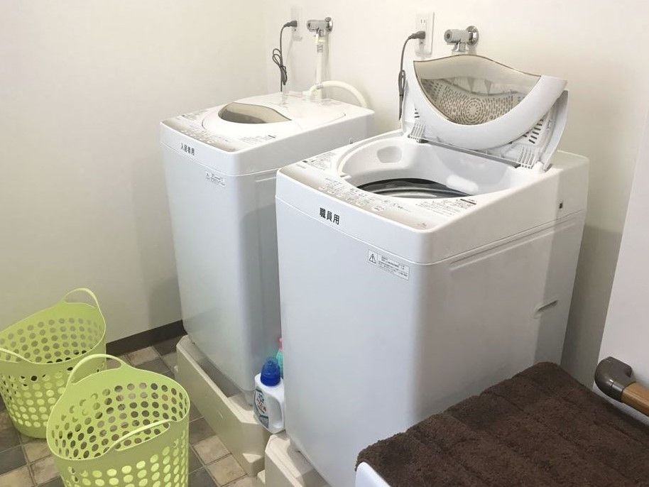 洗濯機は２台置いている。１台は入居者様が共用しており、１台は職員が利用している。洗剤やバスケットが置いてある。