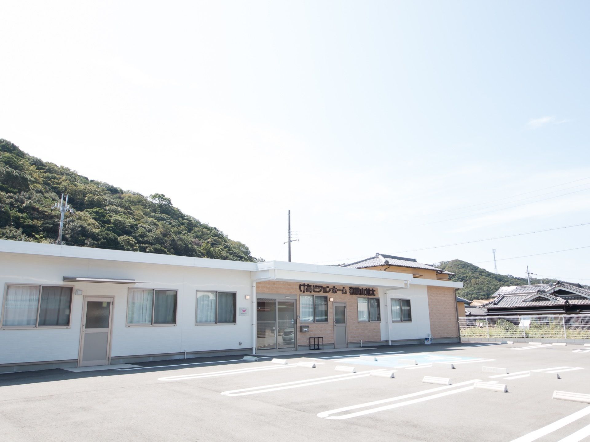 施設は平屋建ての建物である。広い駐車場が建物前に完備されている。エントランスには、ひさしが設置されている。