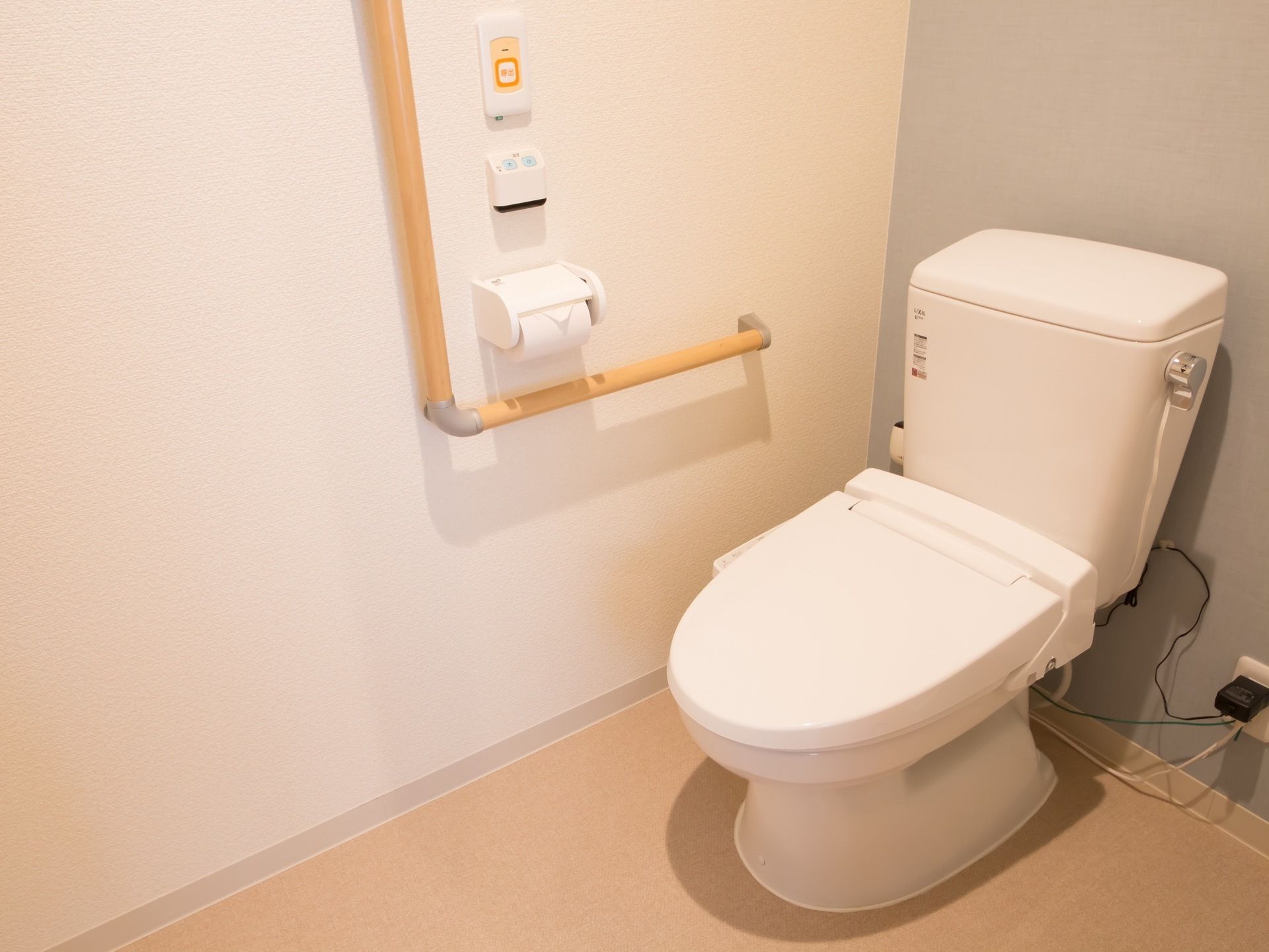 トイレはシンプルな造りである。壁面に手すり、緊急ボタンが取りつけられており安全面にも配慮されている。
