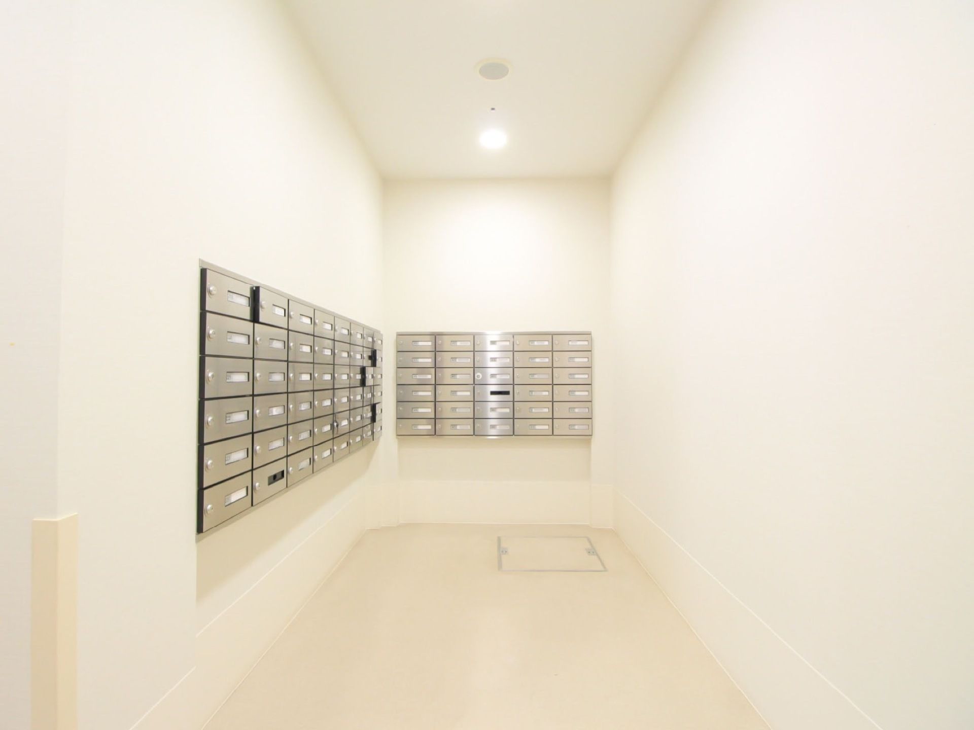 白を基調とした明るいフロアに、各入居者様専用のポストが設置されている。各扉には、鍵が掛けられるようになっている。