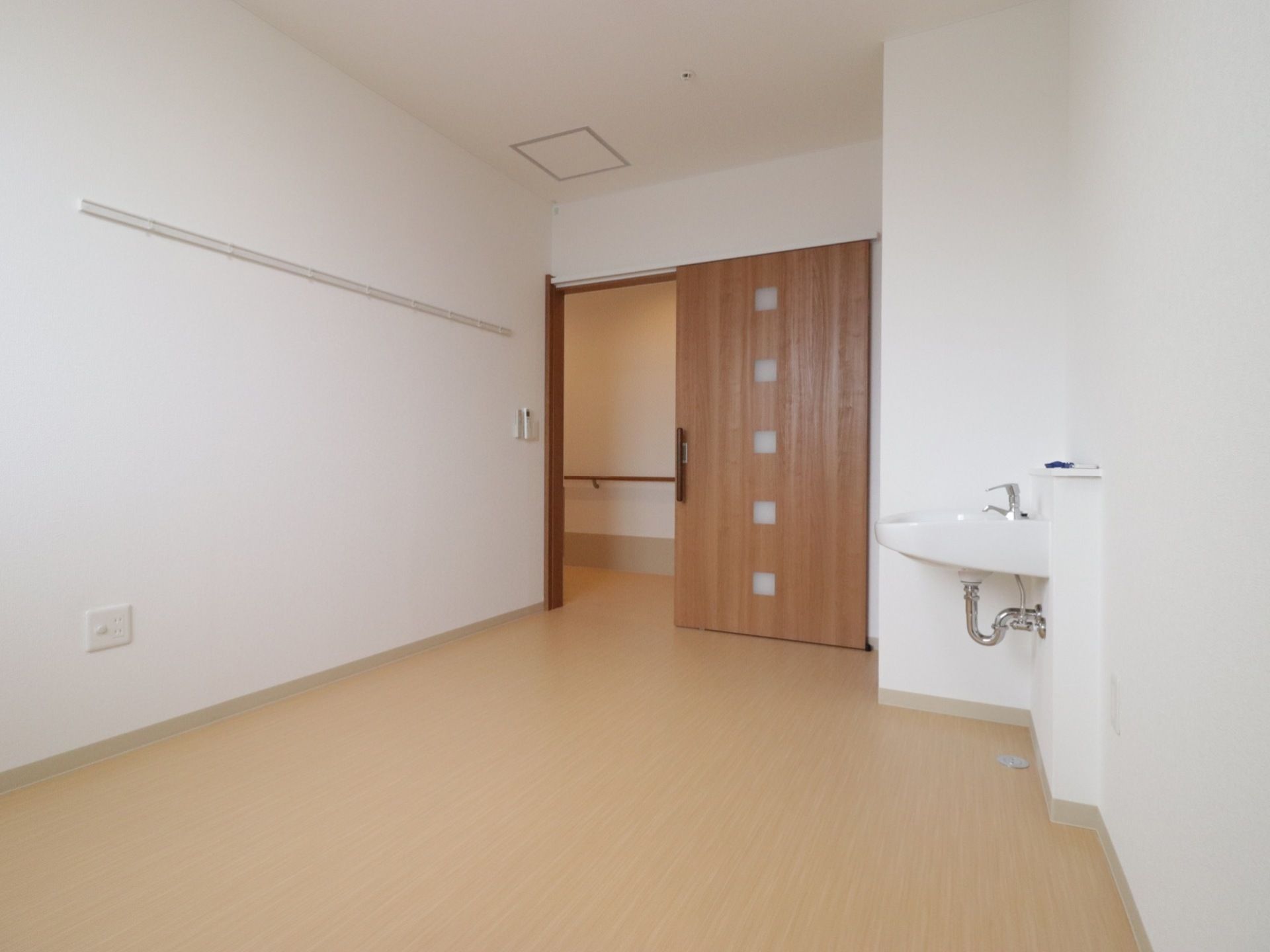 居室はフローリングになっている。洗面台とクローゼットが備えつけられている。入口の扉は、開け閉めしやすいスライド式を採用している。