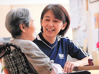 スタッフが話しかけている様子。笑顔で答える高齢者