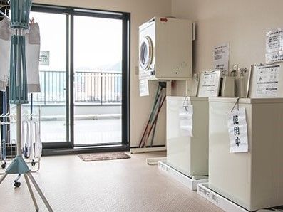 縦型洗濯機と乾燥機が設置されたランドリースペース。等身大の窓があり、屋上に出ることができる。