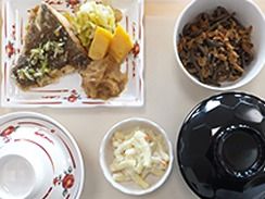 魚料理を中心とした食事。ごはんやすいものの器には蓋がされていて、きれいに盛り付けられている。