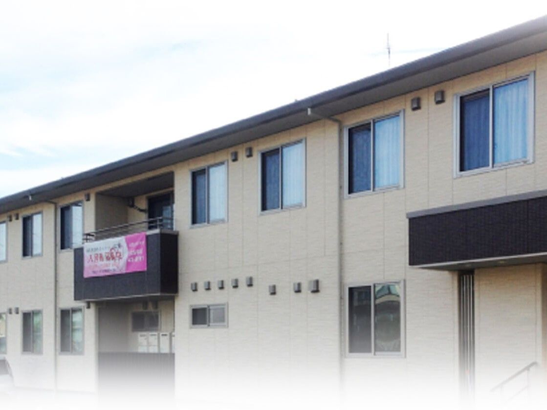 ブラウン系の２階建ての建物は横に長くすっきりとした印象。