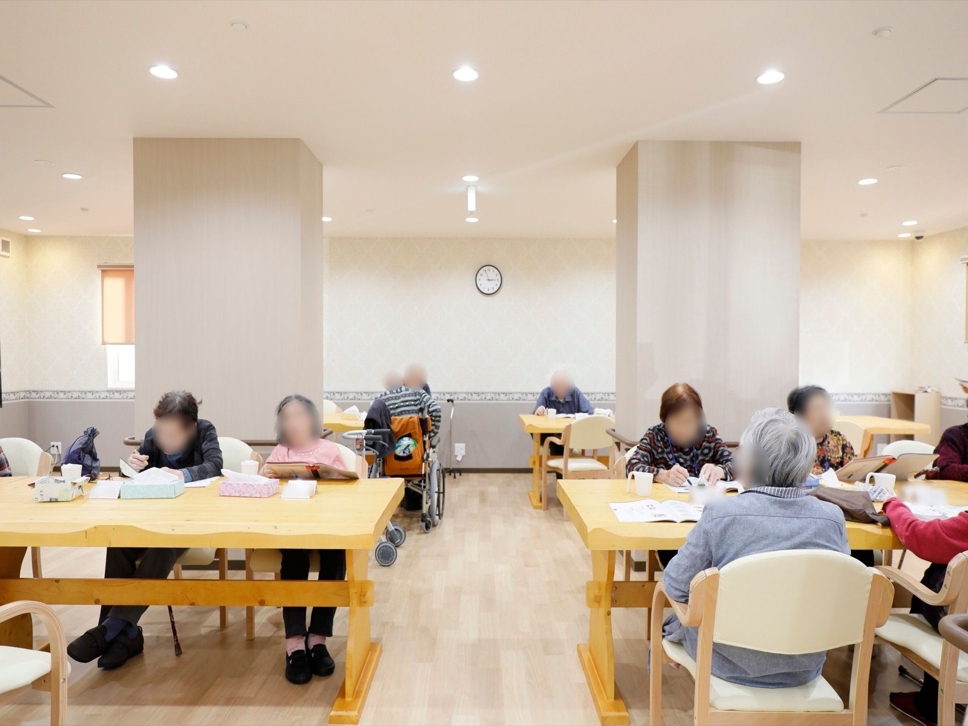 広々とした共有スペースでそれぞれくつろいでいる入居者様