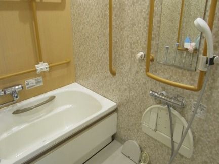 一般家庭にある浴室と変わらないサイズの浴室。手すりが壁全体に設置されていて安全に使用できる。