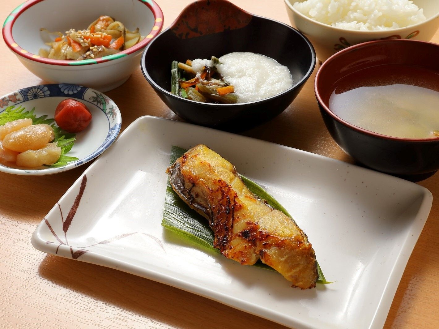 食堂での食事風景。入居者の前にはきれいに盛られた食事が並び、楽しそうに食事をしている。