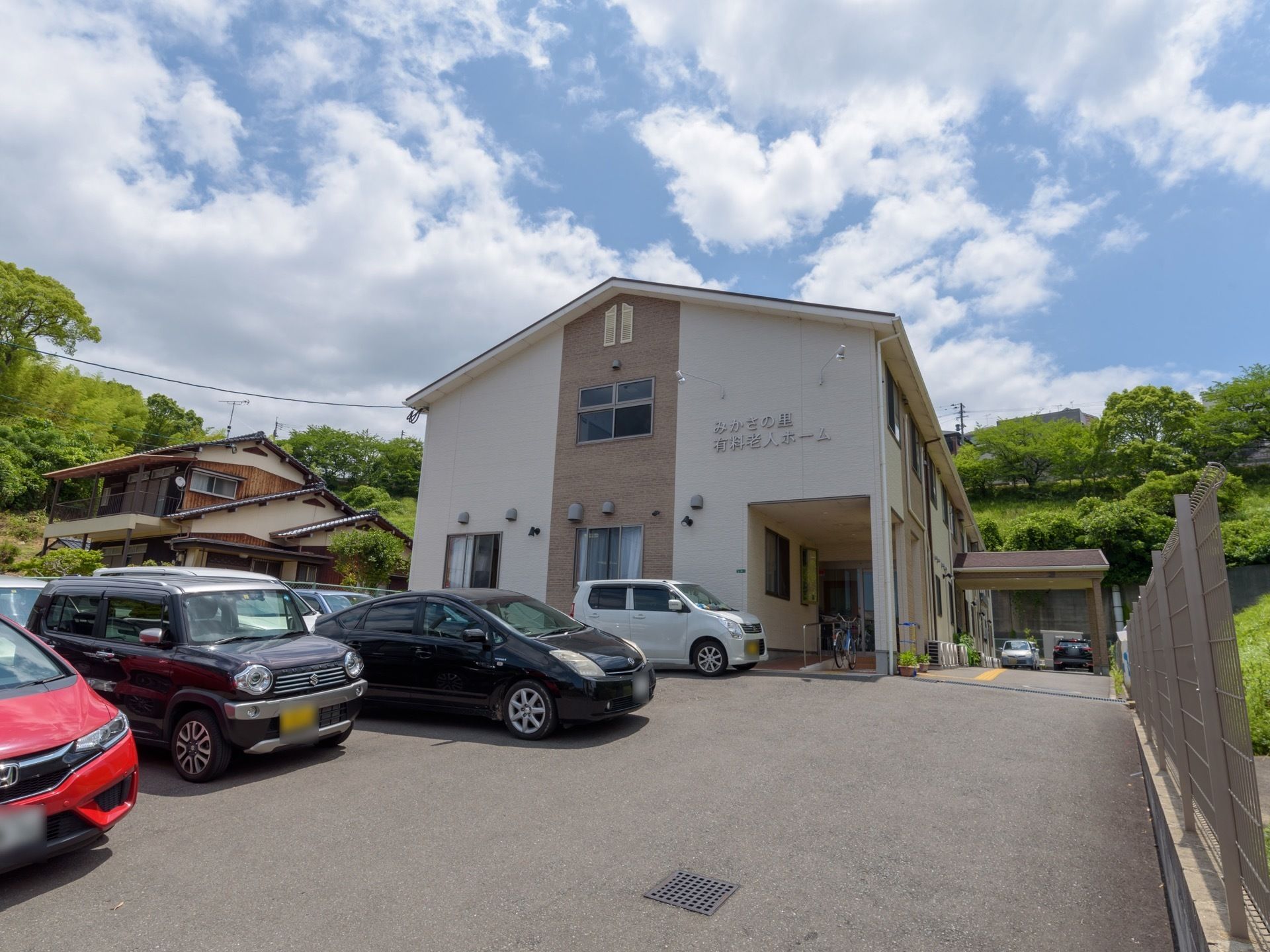 建物の周囲は住宅と緑に囲まれて、高い建物がなく日当たりは良好。外壁は明るい色合いのツートンカラーで、おしゃれな雰囲気。