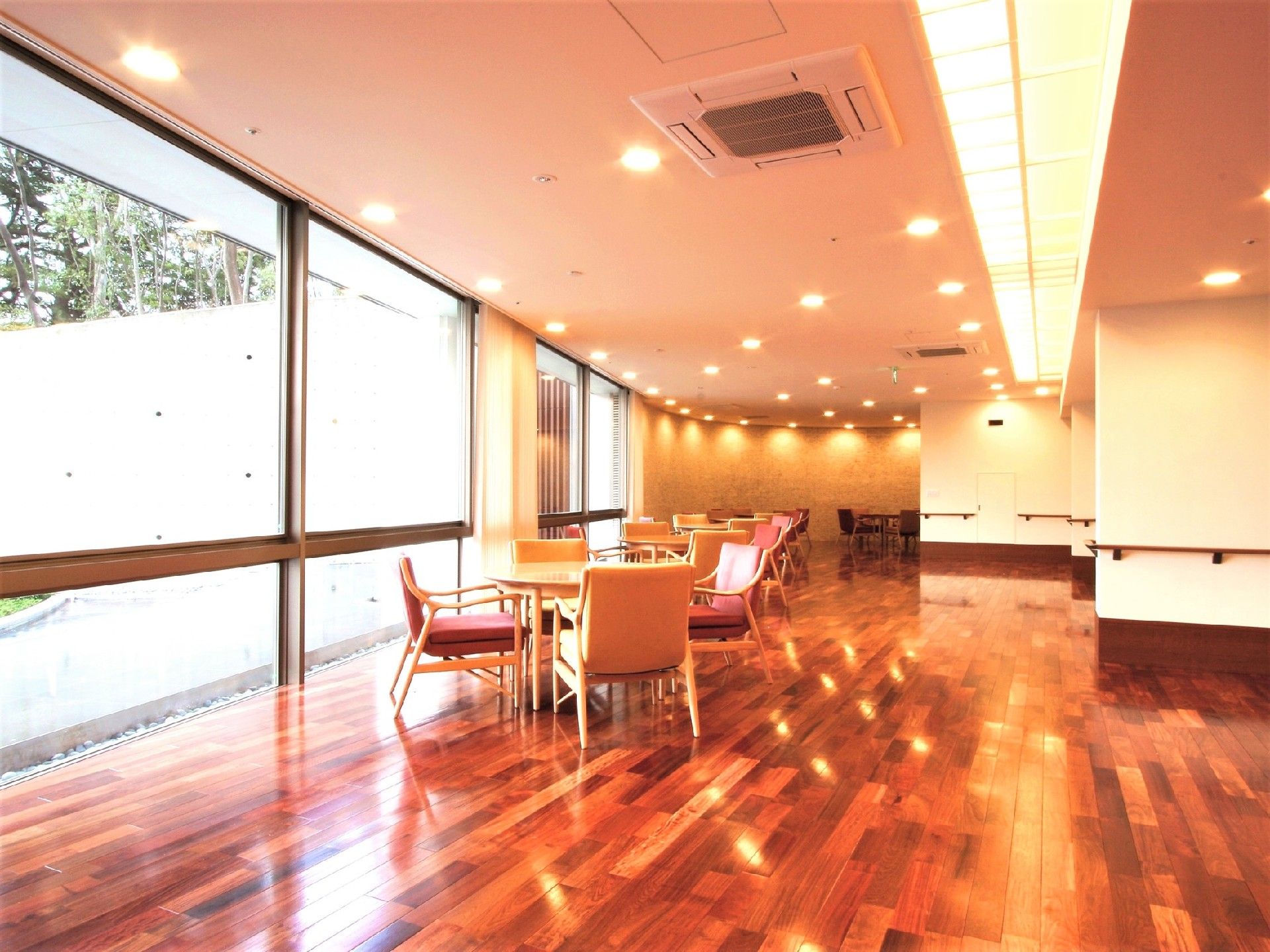 窓が非常に大きく、明るい雰囲気のラウンジである。ゆったり座れるテーブルのセットがいくつも置いてある。