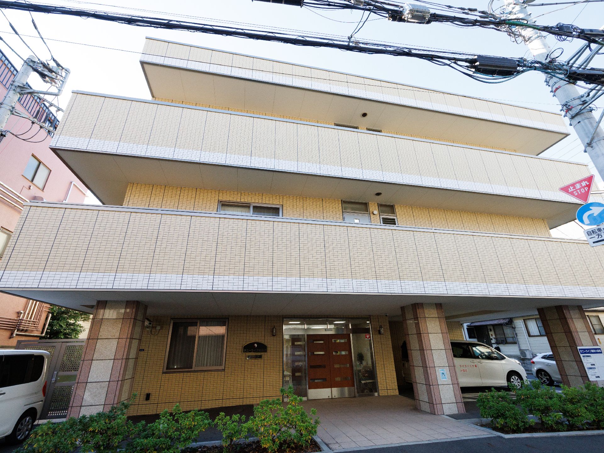 道路に面して建っているベージュの建物