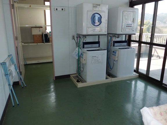 洗濯機と乾燥機が置いてあるランドリースペースの様子。施設内の設備の写真