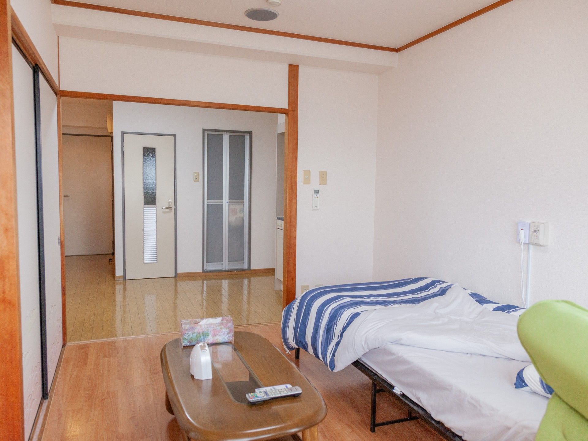 大きな窓が付いた広い部屋にはソファベッドがあり、壁にはエアコンもついている。日当たり良好。