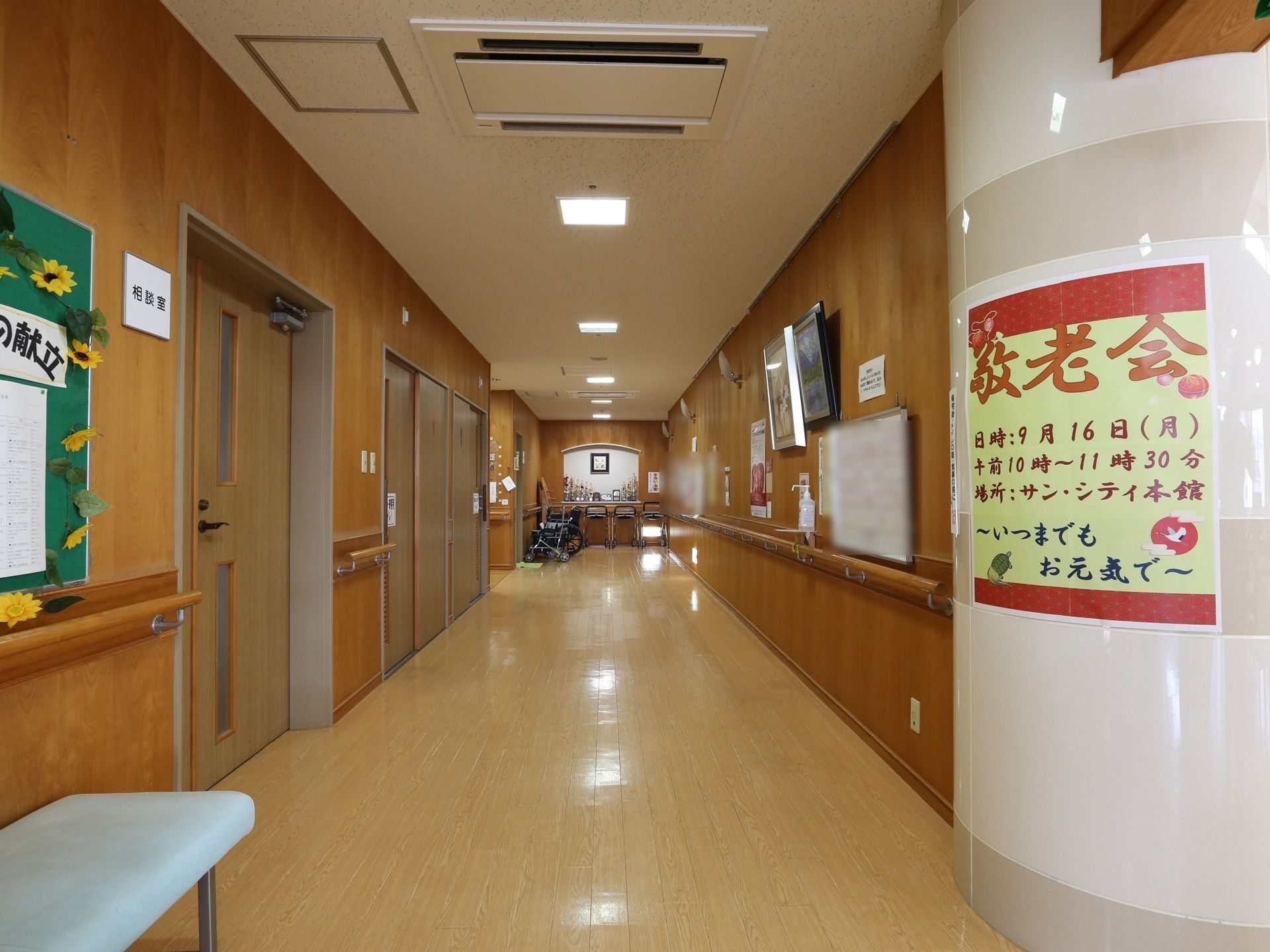 奥行きのある共用廊下。右側の壁には額装の絵画を設置している。入居者様は通行の際にいつでも鑑賞することができる。