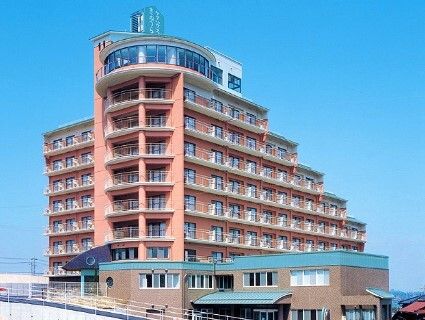 オレンジ系の外壁の10階建ての建物の周りには背の高い建物がなく、日当たり良好。各フロアにベランダもある。