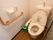 トイレはふたつきの便座で、暖房洗浄機能がついている。トイレットペーパーホルダーの右横に緊急呼び出しボタンが設置されている。