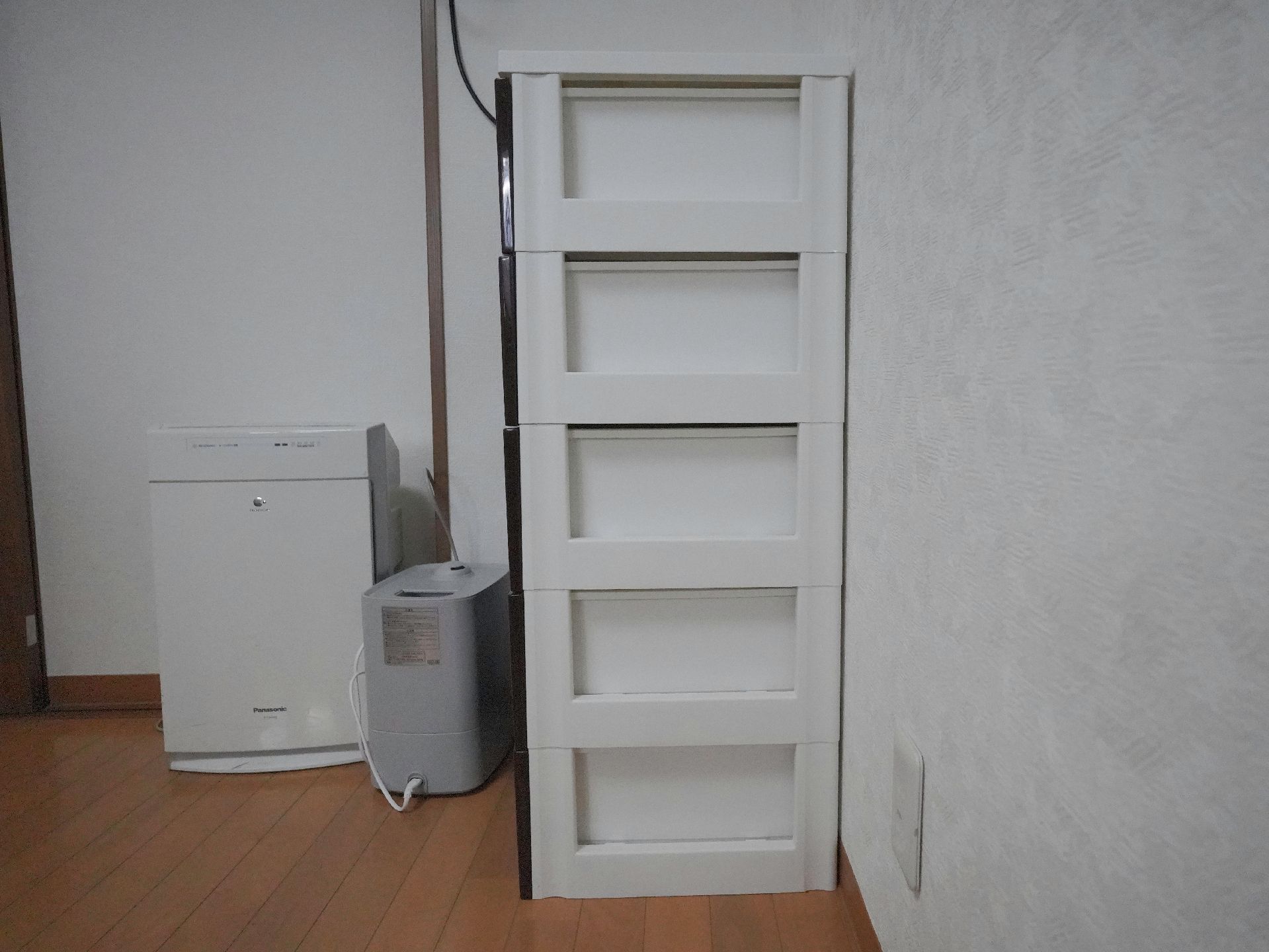 屋外で笑顔で過ごしている車いすの高齢女性と付き添いの若い女性スタッフ。