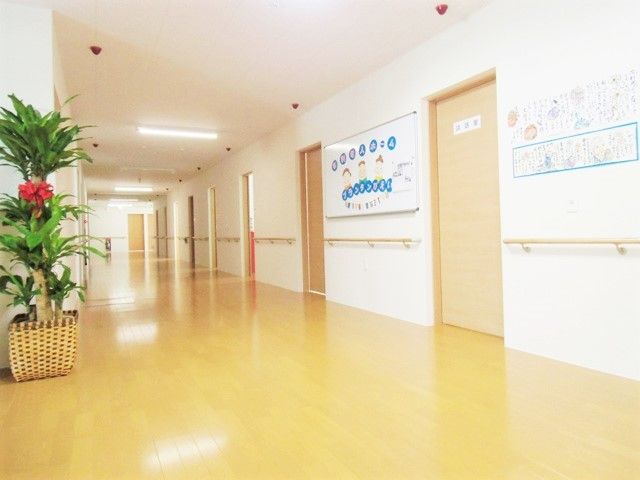 広い廊下には手すりが付き、壁にはアットホームな雰囲気の絵などが飾られている。