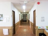 施設内の廊下を写した写真。フローリング仕様で手すりが取り付けられているのが分かる