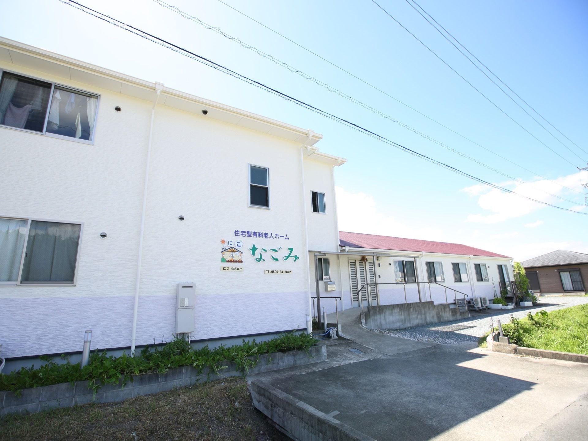 赤い屋根と白い壁が美しい温かみを感じる建物である。周辺には緑豊かな静かな環境であり、アスファルトで舗装されている。