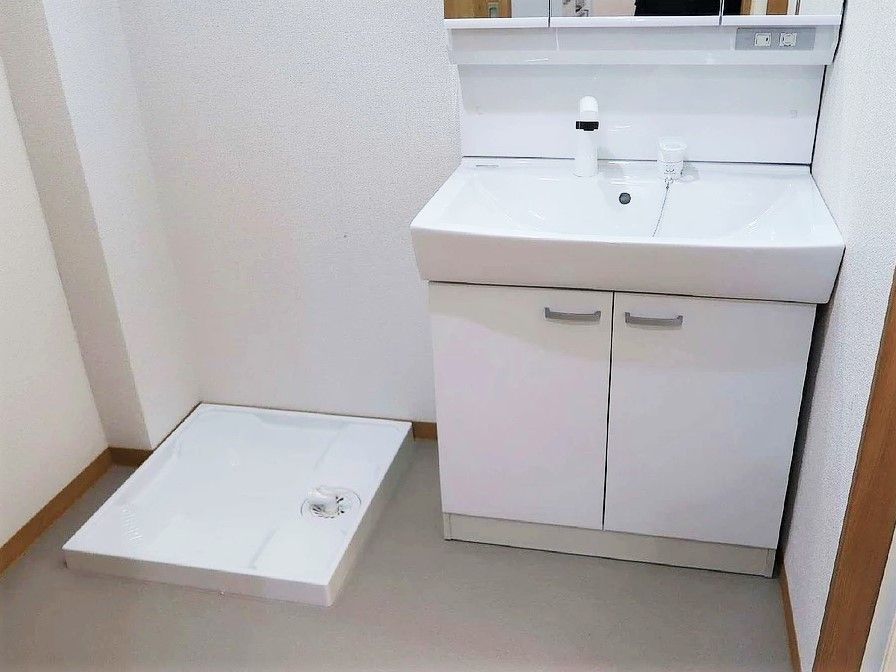 手前に洗面台、洗濯機置き場がある人利用の居室の様子